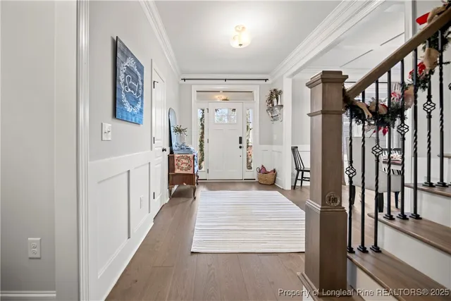 a view of a hallway with a white walls and stairs