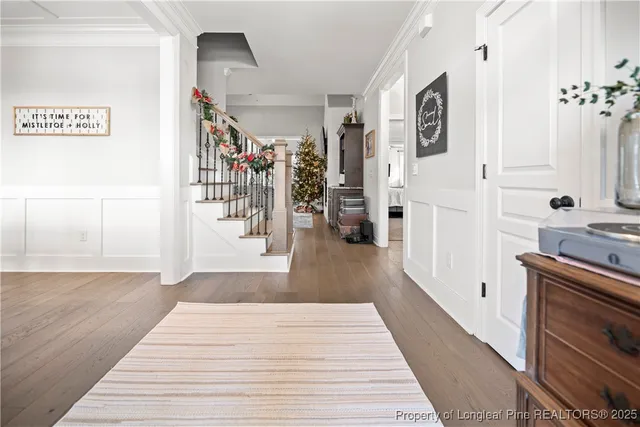 a hallway view with fireplace and wooden floor