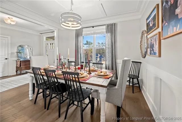 a view of a dining room with furniture wooden floor and chandelier