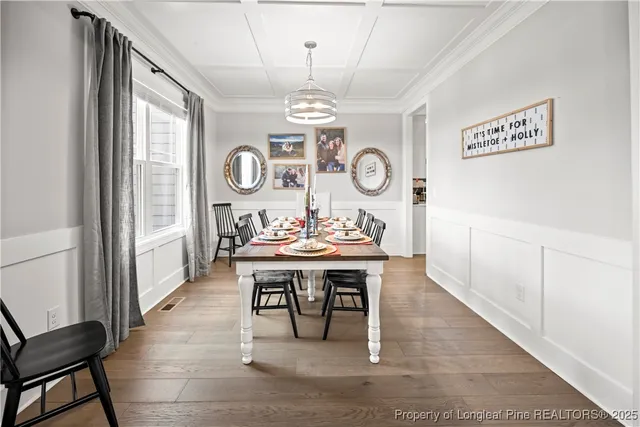 a living room with a table and a clock