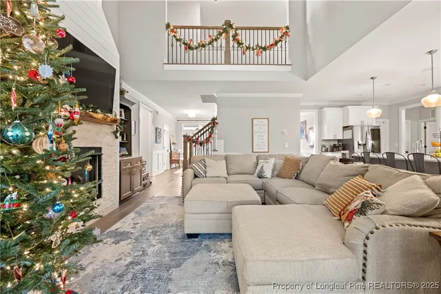 a living room with furniture a flowers and a fireplace