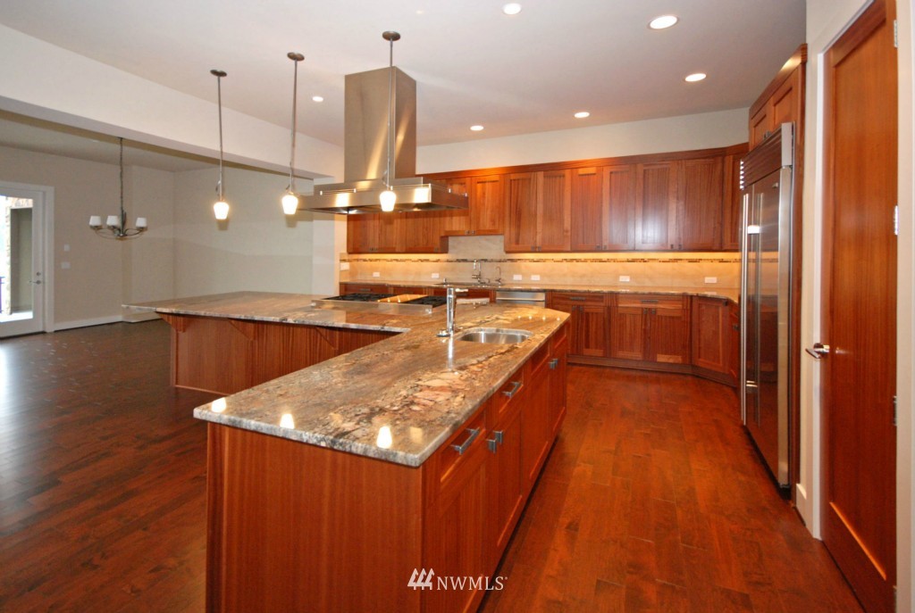 4157 Williams Avenue North Renton, WA 98056 - Photo 2 of 7 a kitchen with stainless steel appliances granite countertop a sink a stove and a wooden floors