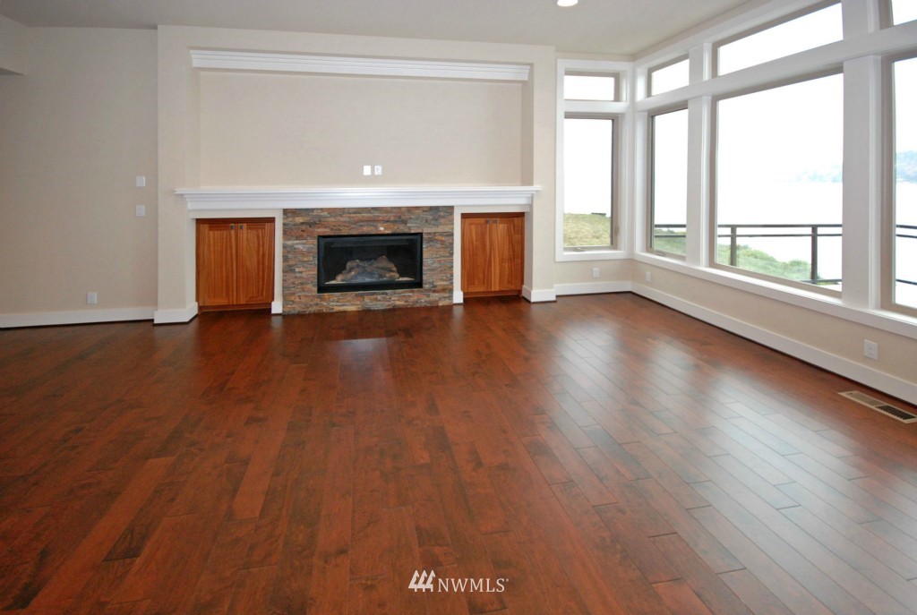 4157 Williams Avenue North Renton, WA 98056 - Photo 4 of 7 an empty room with wooden floor and fireplace