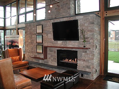 4157 Williams Avenue North Renton, WA 98056 - Photo 6 of 7 a living room with furniture a flat screen tv and a fireplace