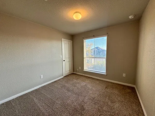 an empty room with a empty space and windows