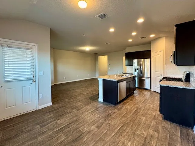 a kitchen with a sink stove and refrigerator