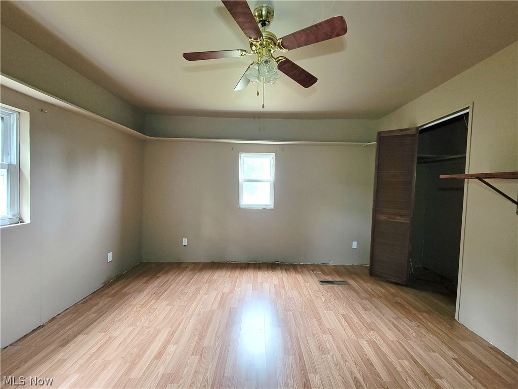 63 Old Ashby Ridge Road Parkersburg, WV 26104 - Photo 8 of 13 Unfurnished bedroom featuring light wood-type flooring, ceiling fan, and a closet