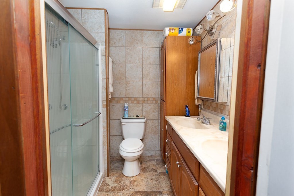 242 Peakland Road Decatur, TN 37322 - Photo 29 of 39 a bathroom with a sink a toilet and shower