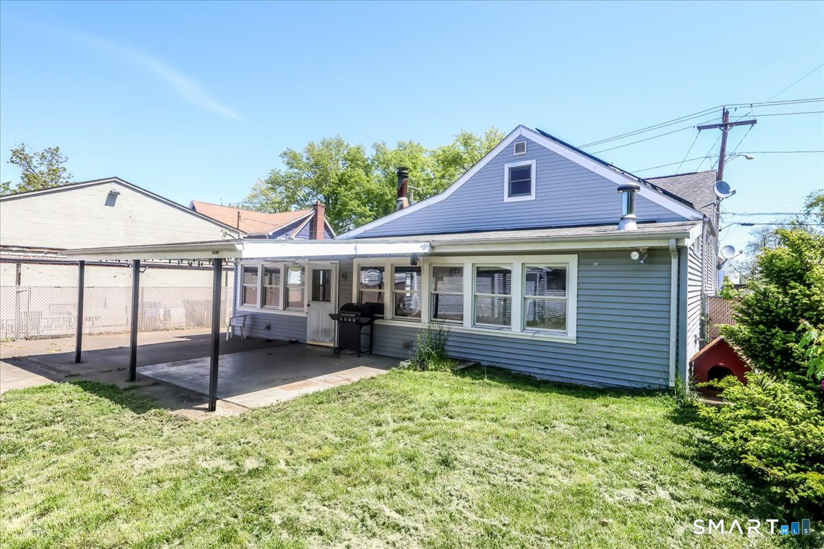 306 Welton Street Hamden, CT 06517 - Photo 35 of 38 a front view of a house with a garden and patio