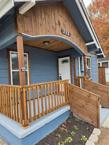 a view of a house with a wooden fence