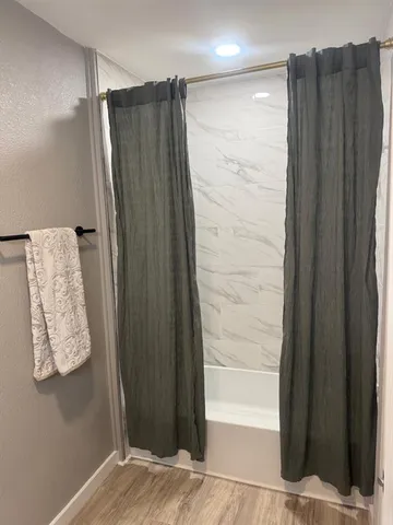 a bathroom with a shower and a glass door