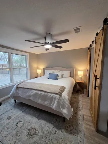 a bedroom with a bed and a large window