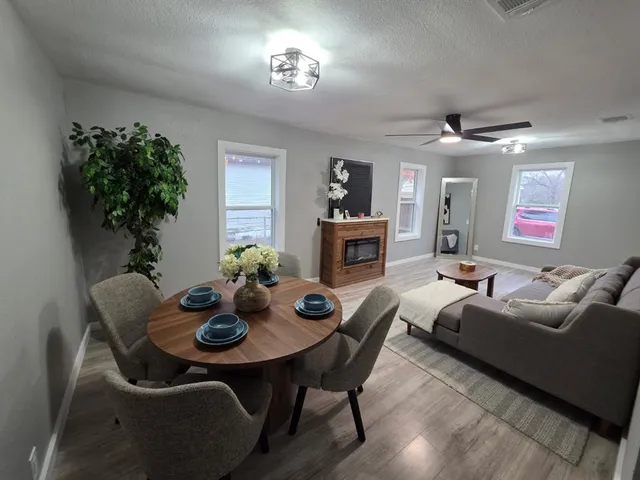a view of a dining room with furniture and chandelier