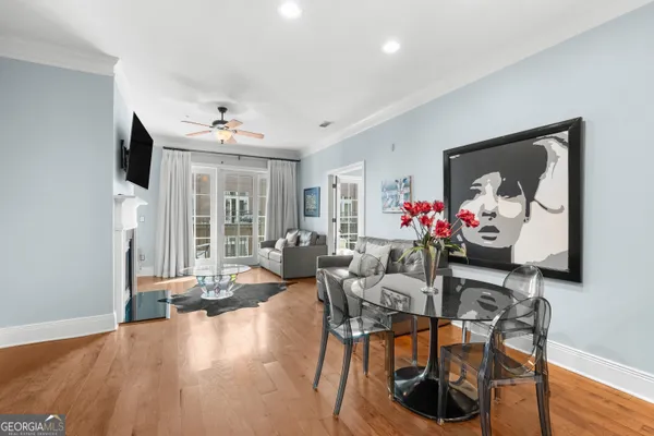 a living room with furniture kitchen view and a chandelier