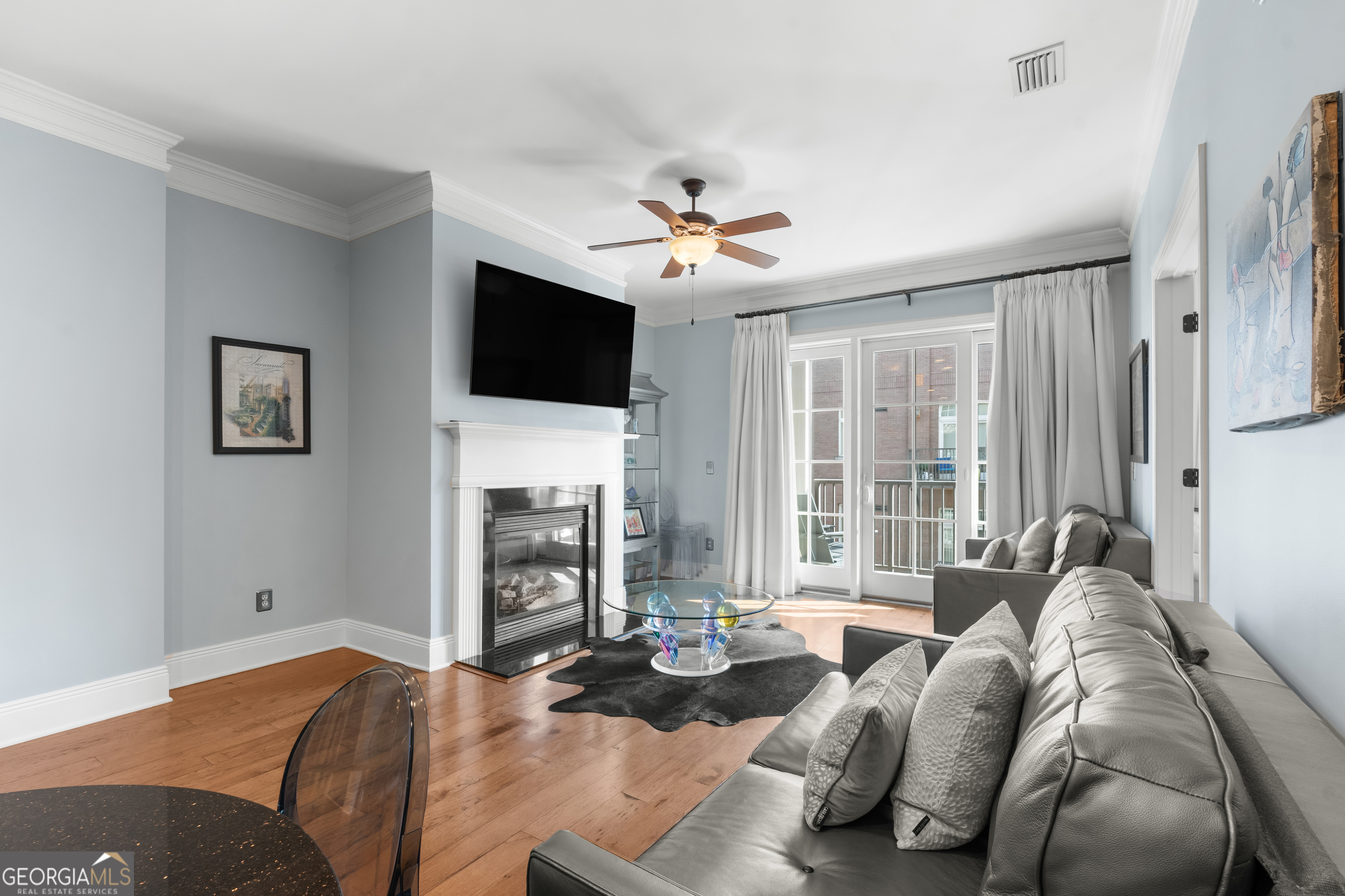 165 West Bay Street, Unit 402W Savannah, GA 31401 - Photo 14 of 37 a living room with furniture a fireplace and a flat screen tv