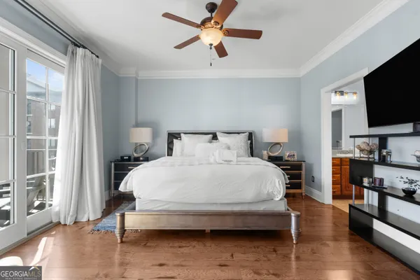 a bedroom with a bed and a flat screen tv