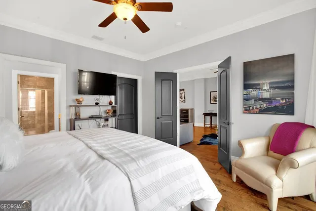 a bedroom with bed and wooden floor