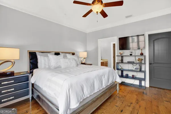 a bedroom with a bed and a lamp