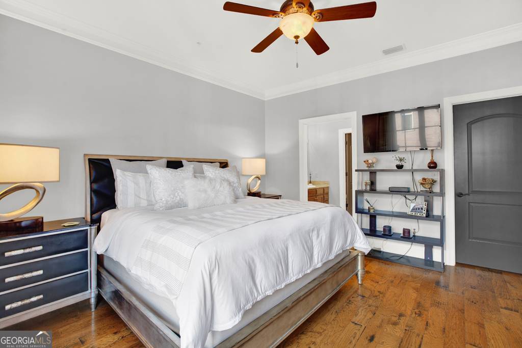 165 West Bay Street, Unit 402W Savannah, GA 31401 - Photo 18 of 37 a bedroom with bed and wooden floor