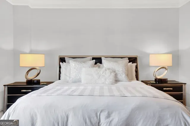 a bedroom with a bed and a lamp