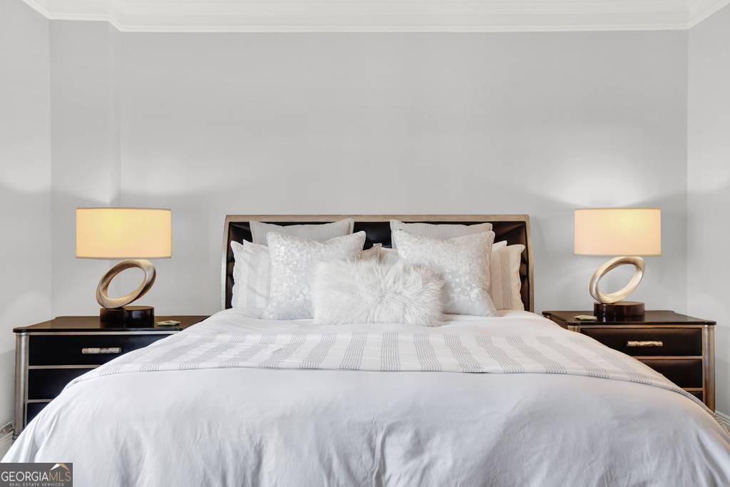 165 West Bay Street, Unit 402W Savannah, GA 31401 - Photo 19 of 37 a bedroom with a bed and a lamp