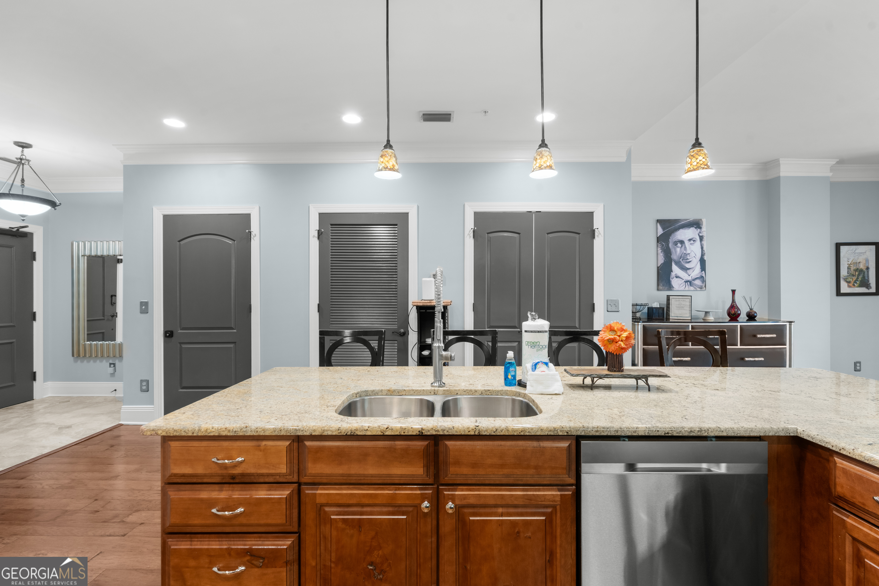 165 West Bay Street, Unit 402W Savannah, GA 31401 - Photo 7 of 37 a kitchen with kitchen island granite countertop a sink and refrigerator