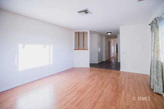 2007 Pickrell Street Ridgecrest, CA 93555 - Photo 9 of 37 a view of an empty room with wooden floor and a window