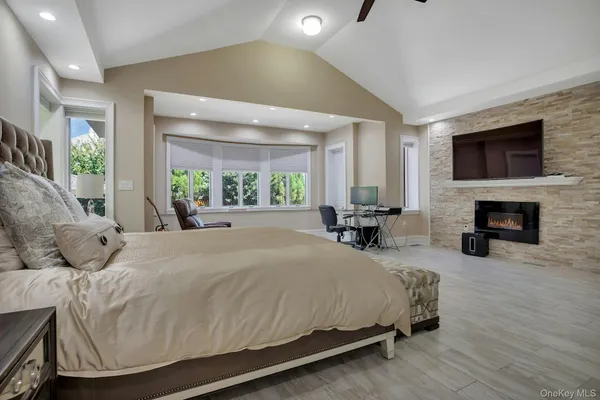 a bedroom with a large bed and a flat screen tv
