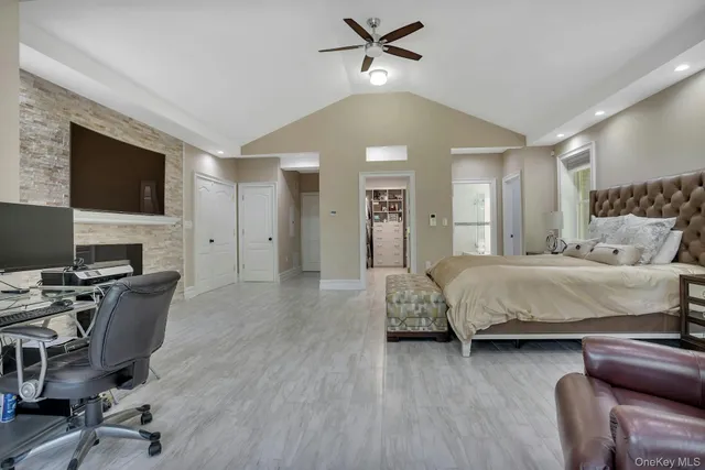 a spacious bedroom with a bed and a desk