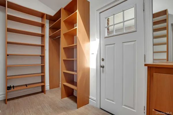 a view of walk in closet with empty racks
