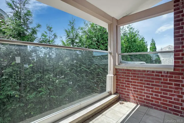 a view of a balcony with floor to ceiling windows and wooden floor