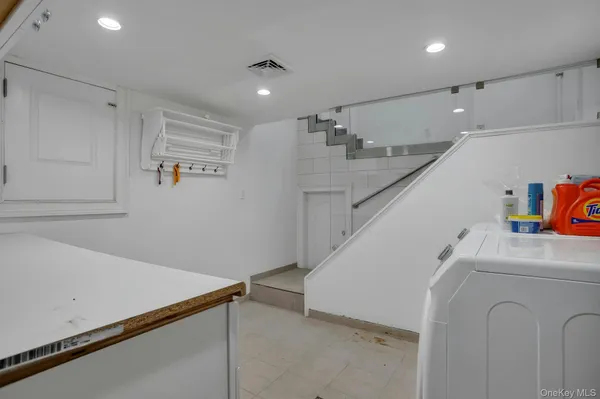a view of storage and utility room with stairs