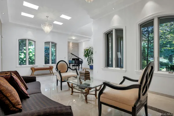a living room with furniture and large windows
