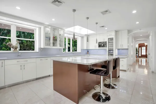 a kitchen with stainless steel appliances granite countertop a sink a stove and a refrigerator