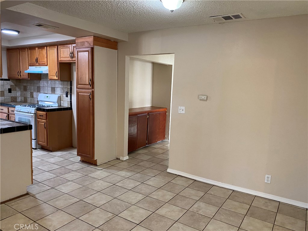 18746 Rock Springs Road Hesperia, CA 92345 - Photo 7 of 21 a view of a kitchen with wooden floor and a window