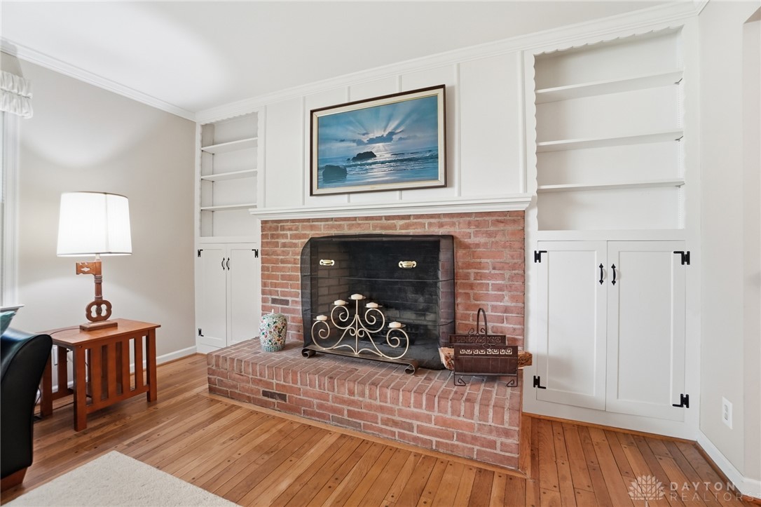 6119 Flemington Road Dayton, OH 45459 - Photo 5 of 76 Warm and inviting, this living area features built-in shelving and a classic brick fireplace.