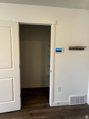562 Hal Street, Unit 152 Tooele, UT 84074 - Photo 6 of 44 Room entrance with wood-finish flooring, white trim, and a built-in wall organizer