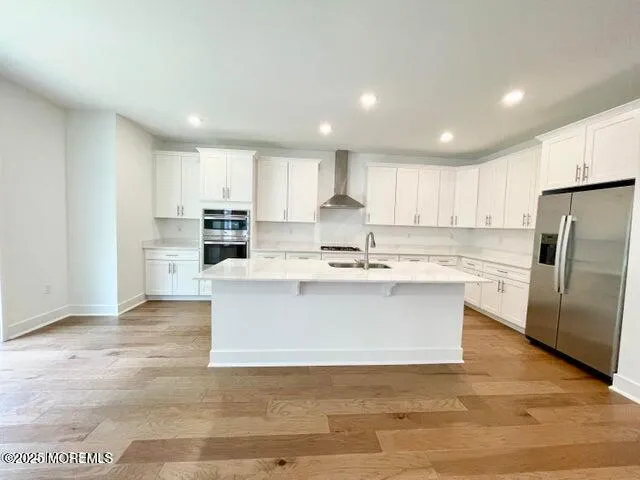 a view of kitchen with wooden floor and electronic appliances