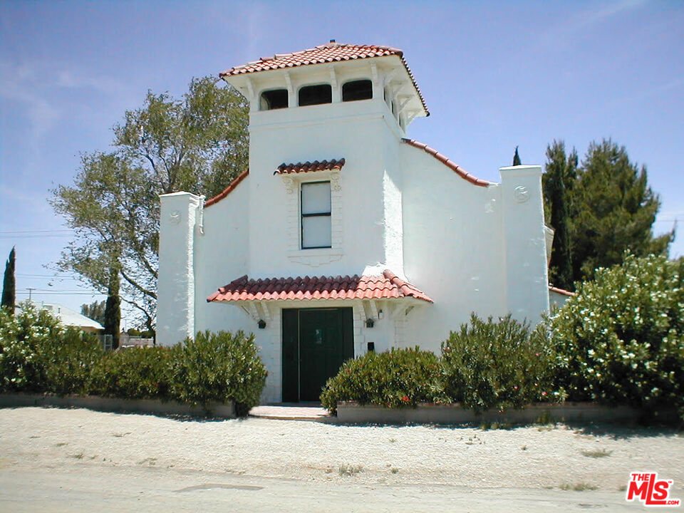 a front view of a house with plants