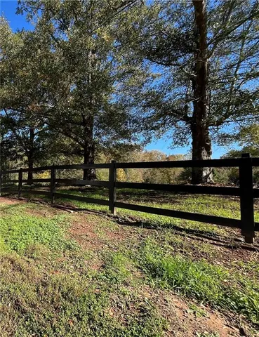a view of backyard with wooden fence