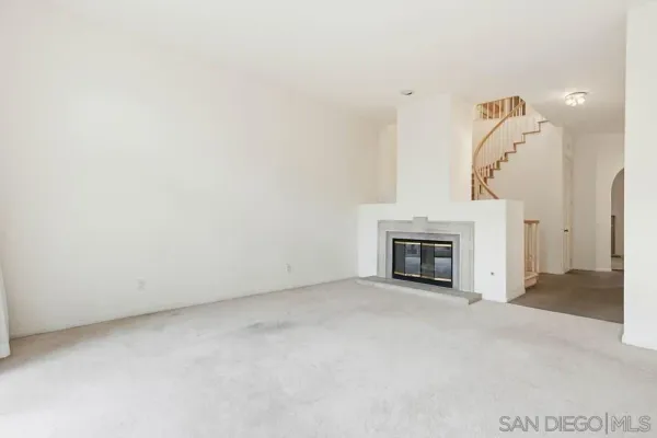 a view of an empty room with a fireplace