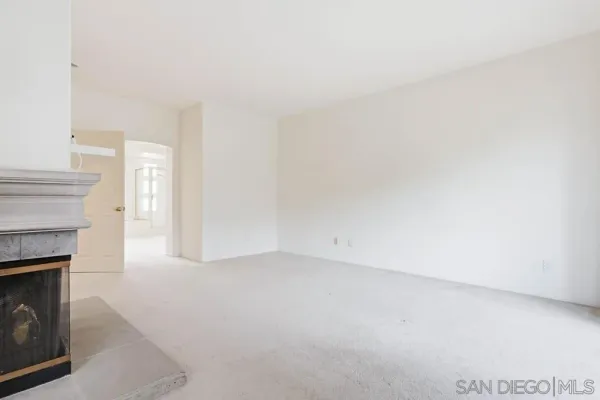 a view of empty room with a fireplace