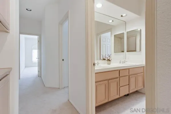a bathroom with a double vanity sink and mirror