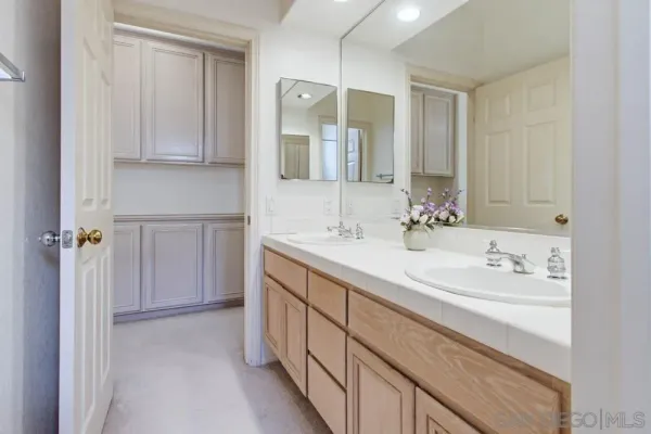 a bathroom with a double vanity sink mirror and