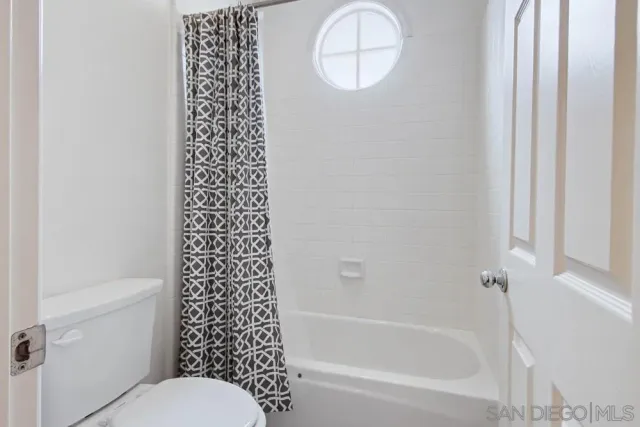 a bathroom with a bathtub a toilet and a shower