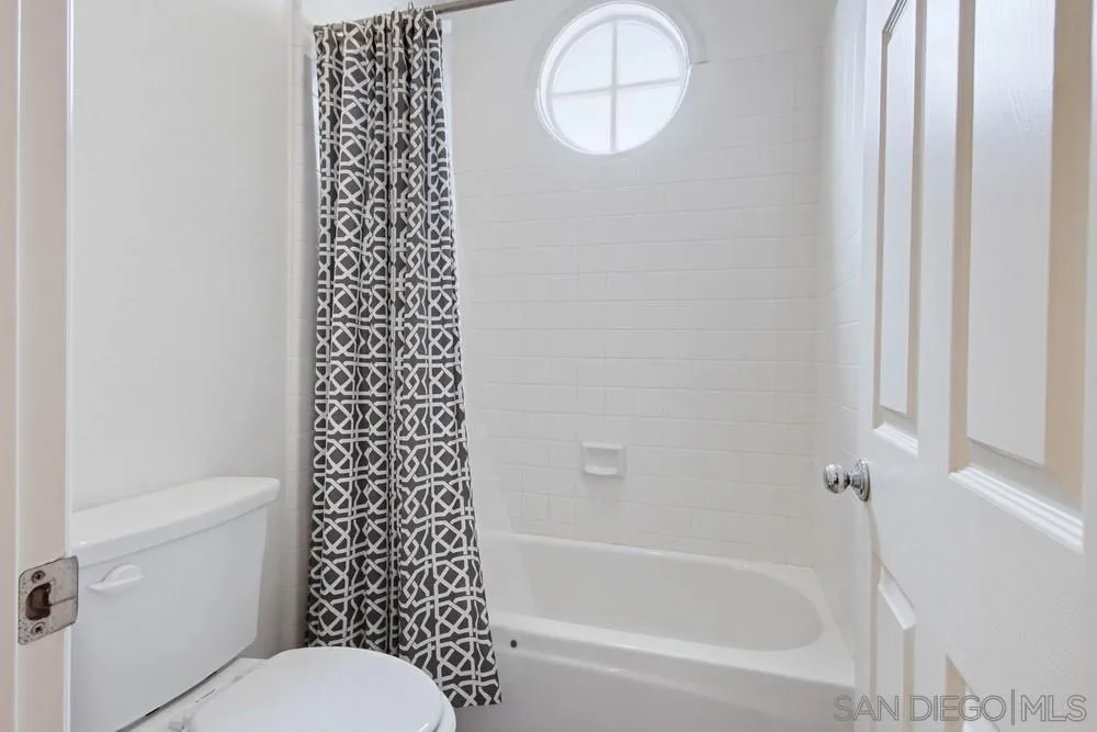 5226 Renaissance Avenue San Diego, CA 92122 - Photo 32 of 41 a bathroom with a bathtub a toilet and a shower
