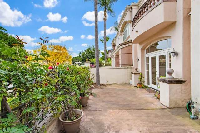 a view of a garden with a building in the background