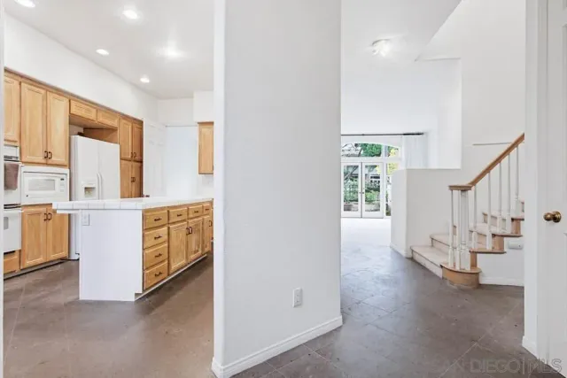 a view of kitchen with furniture and an empty room