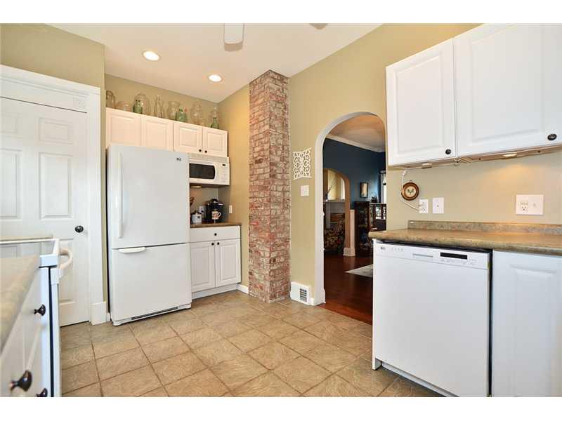419 Ridgeway Street Greensburg, PA 15601 - Photo 7 of 15 Kitchen. View of kitchen toward dining room. Unfinished chimney adds nice architectural touch. Dishwasher, refrigerator and microwave are included. Updated lighting.