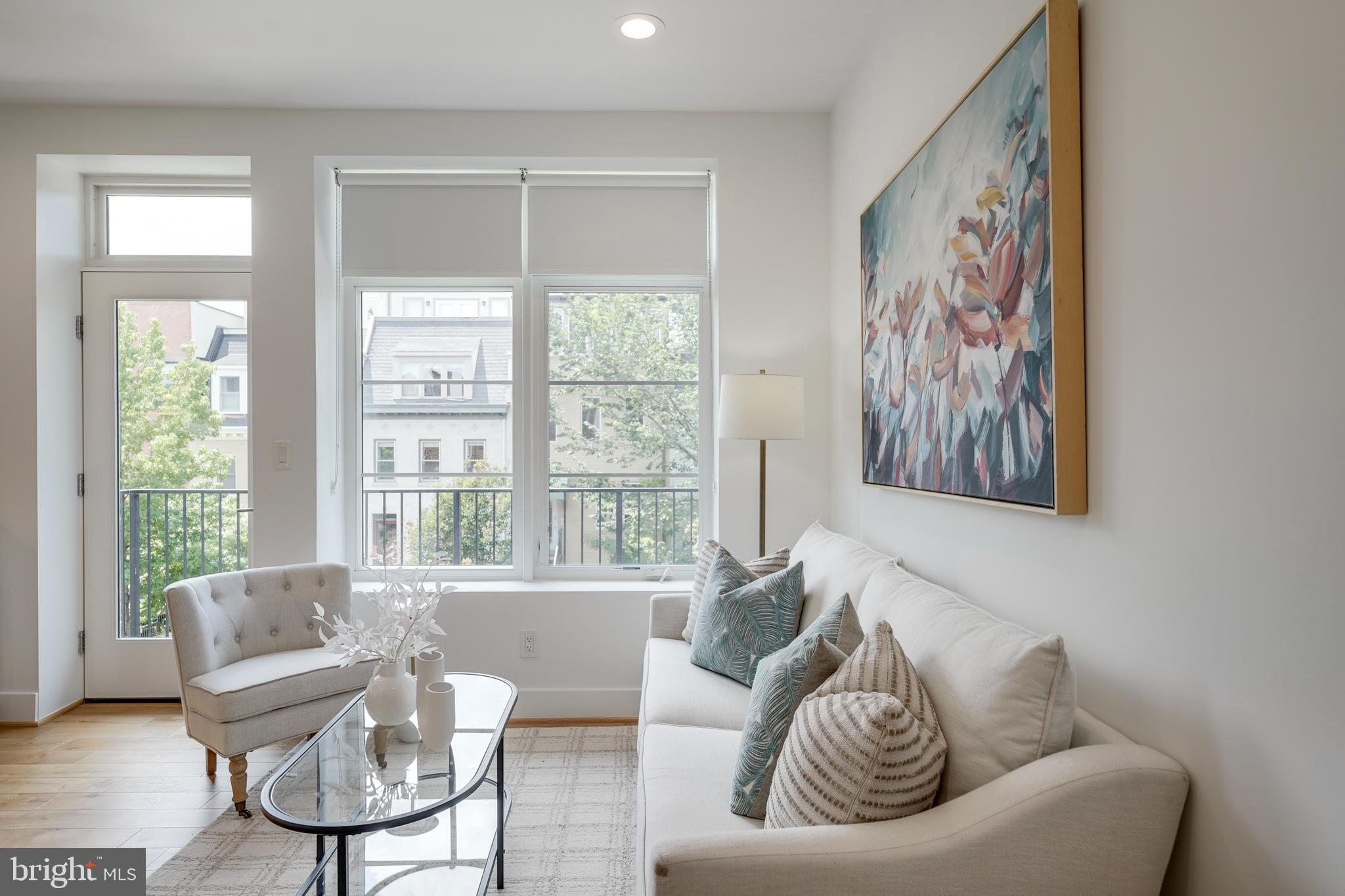 2419 Ontario Road Northwest, Unit 202 Washington, DC 20009 - Photo 4 of 15 a living room with furniture and a large window